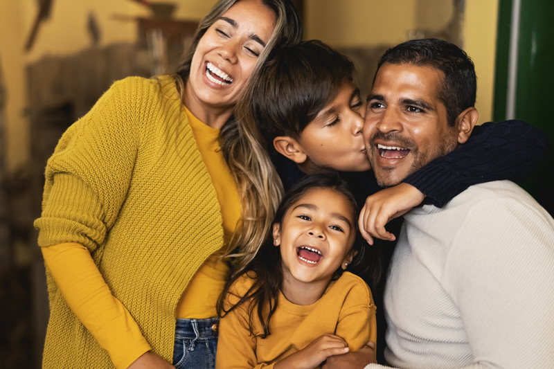 Happy Hispanic family having fun together